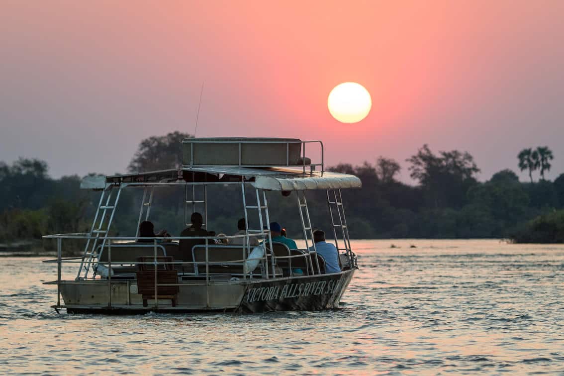 Boat on the river in front of a sunset