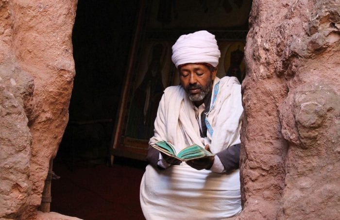 Pilgrim reading in Lalibela churches