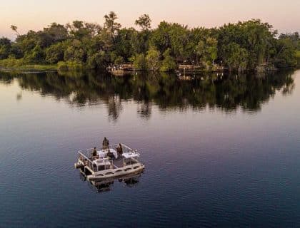 Permanent Water-based camps in Okavango delta, barge dinner in the river 